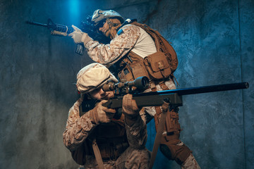 Two well equipped US army commandos armed with assault rifles. Studio shot