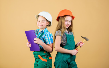 Kids girls with tools planning renovation. Family remodeling house. Children sisters renovation their room. Control renovation process. Kids happy renovating home. Home improvement activity