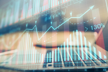 Double exposure of forex chart and work space with computer. Concept of international online...