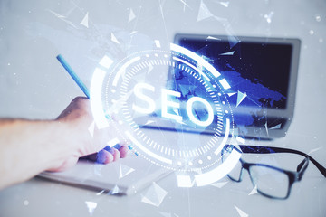 Man hands writing. With double exposure seo drawings.