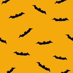 seamless halloween pattern with bats on an orange background