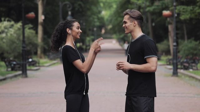 Young Girl and Handsome Man Talking Giving High Five and Going to Different Sides of the Park.