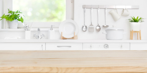 Fototapeta na wymiar Wooden table top on blur kitchen room and window background