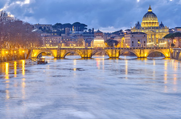 St. Peter's cathedral and Tiber river with high water at evening. Saint Peter Basilica in Vatican city with Saint Angelo Bridge in Rome, Italy