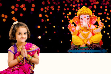 Little indian girl with lord ganesha, Indian ganesh festival