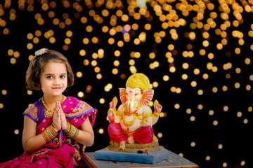 Little indian girl with lord ganesha, Indian ganesh festival