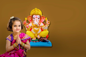 Little indian girl with lord ganesha, Indian ganesh festival
