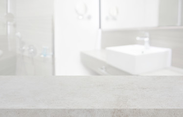 Stone table top and blurred hotel bathroom interior as background