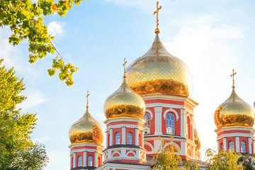 Church in the city of Saratov, Russia, Volga region. Attraction, culture, Religion, Christianity, Church of the Protection of the Holy Virgin. Domes of gold color in the summer sunshine