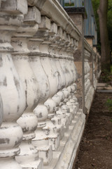 Antique balusters of gray color with cracked white paint. Linear perspective. Creative vintage...