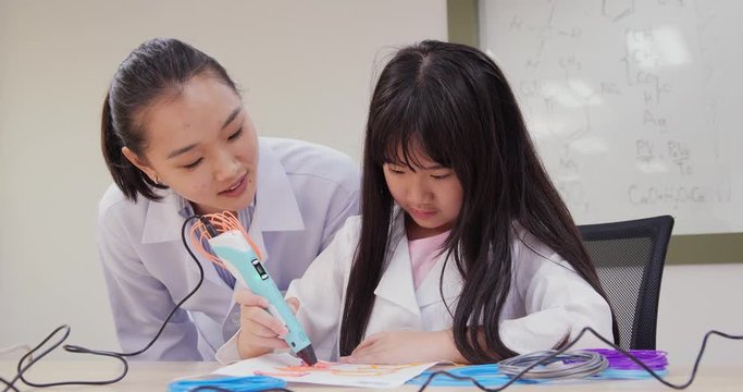 Student using 3d pen at lab. Techer advice little girl using 3d pen at lab. Technology and Innovation concept.