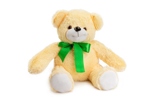 Image of golden toy teddy bear sitting at isolated white background.