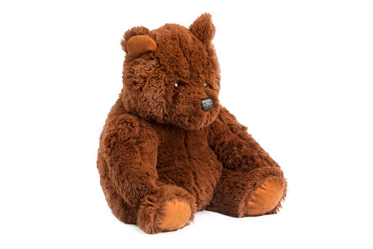 Image of brown toy ugly eddy bear sitting at white isolated background.