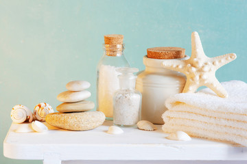 Spa and skincare products on the table across the blue wall
