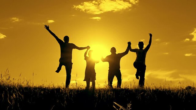 Silhouette of people, jubilation and jumping with show of hands.