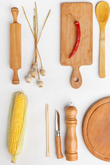 Composition of wooden cutting boards and wooden utensils and kitchen utensils. Top view.