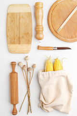 Composition of wooden cutting boards and wooden utensils and kitchen utensils. Top view.