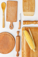 Composition of wooden cutting boards and wooden utensils and kitchen utensils. Top view.