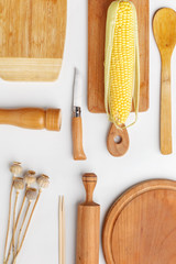 Composition of wooden cutting boards and wooden utensils and kitchen utensils. Top view.