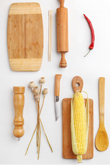 Composition of wooden cutting boards and wooden utensils and kitchen utensils. Top view.