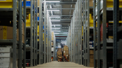 Storage area with boxes, shelves, pallet jack