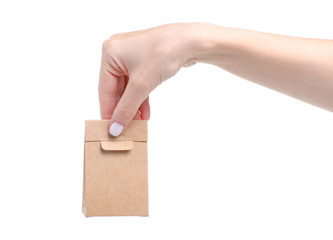 Cardboard brown package in hand on white background isolation