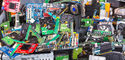E-waste recycling. Used computer parts. Electronic, plastic and metal refuse. Big colorful pile of...