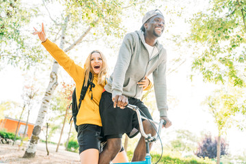 Friends having fun with the bike at the park