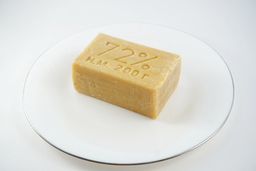 a piece of laundry soap lies on a white plate