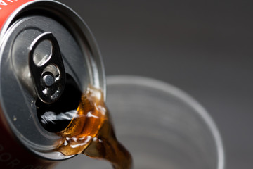 Open cold soda can serving in the glass. Cold soft drinks with excess sugar. Not healthy. Cold drinks.