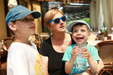 Grandmother with two grandsons in cafe
