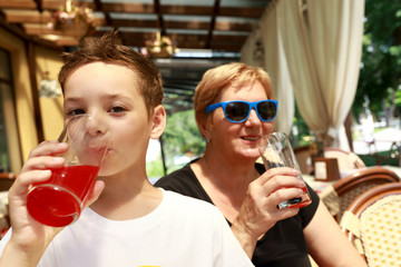 Grandson and grandmother drinking juice