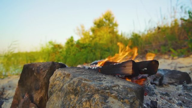 campfire burns in the sand