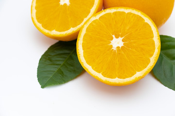 Half of orange and whole with green leaf isolated on white background