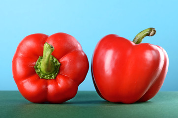 Sweet pepper, paprika on the green table blue background