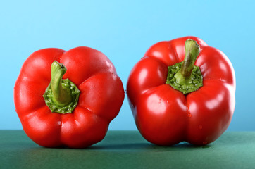Sweet pepper, paprika on the green table blue background