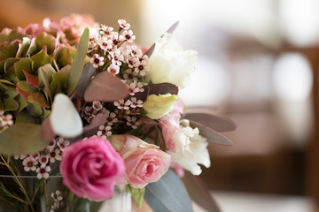 floral bouquet with eucalyptus leaves and pink roses with a blurred background