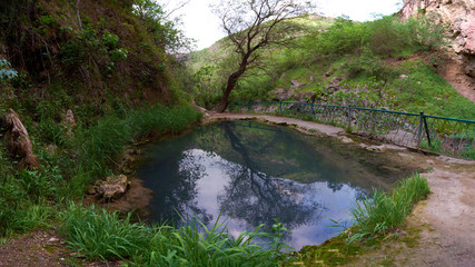 Mountain lake with warm mineral water, located in the gorge.