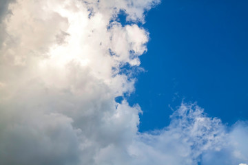 Cumulus clouds gather before the rain against a clear blue sky. Natural landscape.