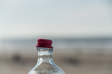 Opened bottle red closure against blury background