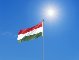 3D illustration. Colored waving flag of Hungary on sunny blue sky background.