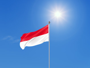 3D illustration. Colored waving flag of Indonesia on sunny blue sky background.