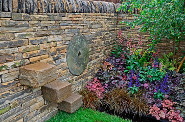 Fototapeta premium The planted border with mixed ground covering planting including Heuchera and Salvia in a country garden