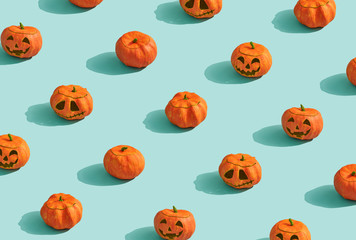 Pumpkins lanterns on turquoise background.