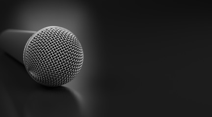 Macro shot of microphone on black glossy table with dof effect.