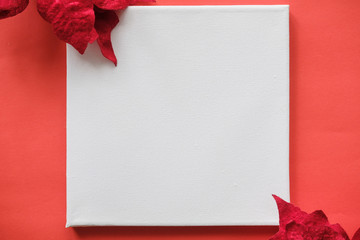 White poster mockup on red background with Christmas decoration . Blank Canvas Mockup for design. Christmas, New Year, shopping, preparation on Holidays, sale, concept.