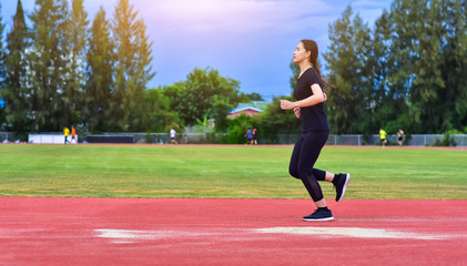 Fototapeta premium Runner Women jogging or running in evening at sunlight,Lady run jogging or exercise,Woman Runner or Girl Running