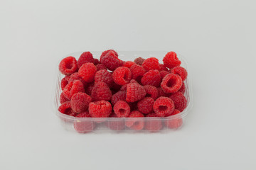 fresh raspberries in a transparent plastic packaging