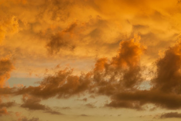 Strange and mysterious sunset sky with golden clouds as alien planet atmosphere background