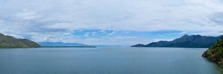 Fototapeta premium View of Boko Kotor on the background of mountains with clouds in the sky on a cloudy day.